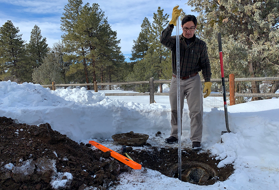 David preforming a septic inspection at a residential home.